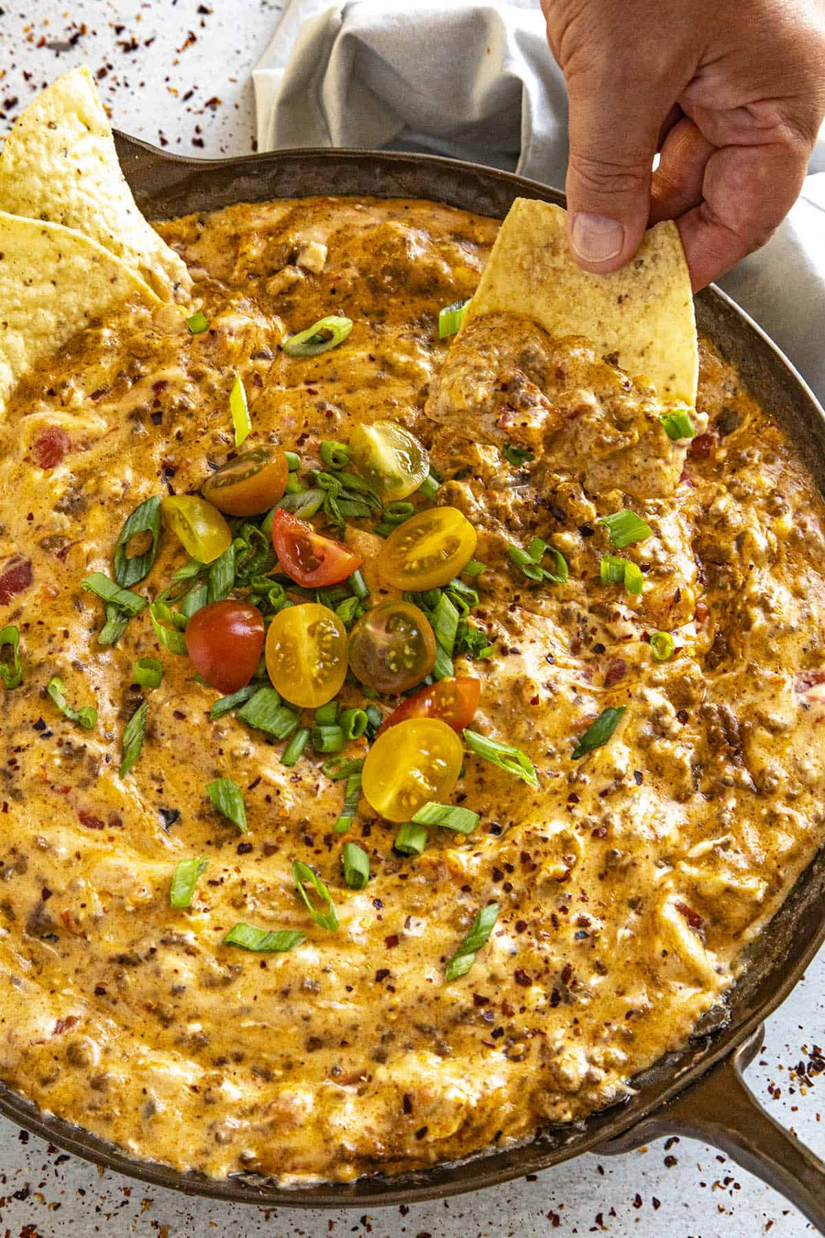 Mike dipping a chip into a pan of gooey Rotel dip