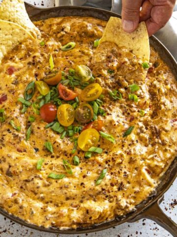 Mike dipping a chip into a pan of gooey Rotel dip
