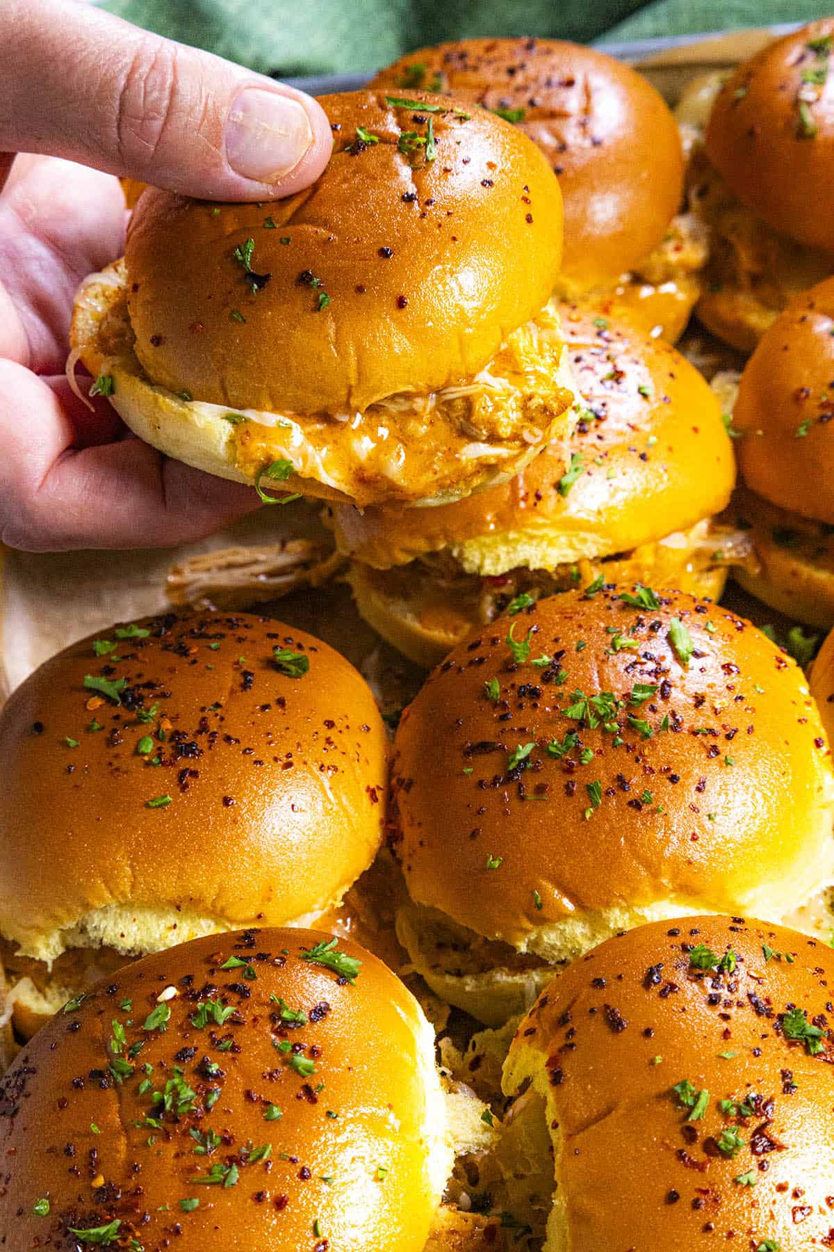 Mike grabbing a Buffalo Chicken Slider from the pan