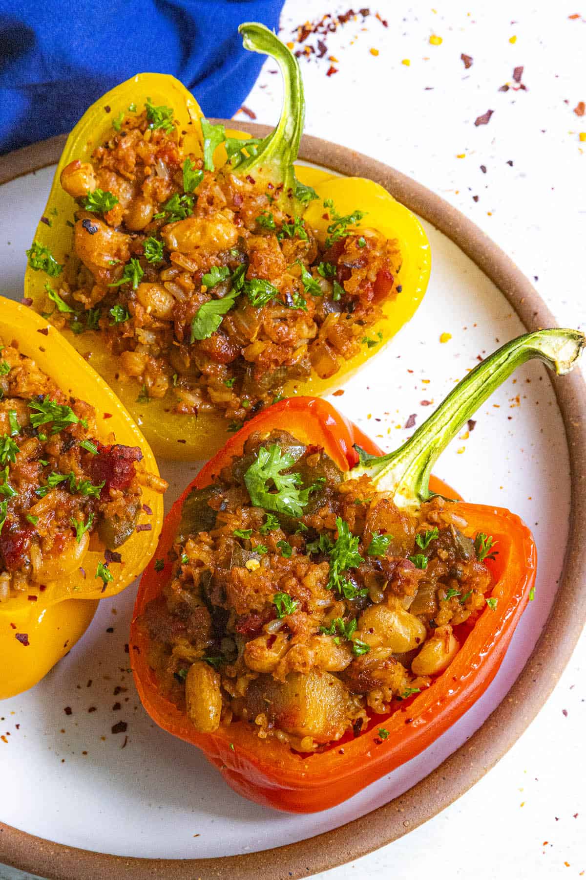 Mike serving a plate full of Vegan Stuffed Peppers