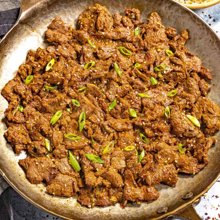 Hot Korean Beef Bulgogi served in a pan with rice on the side