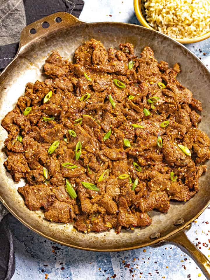 Hot Korean Beef Bulgogi served in a pan with rice on the side