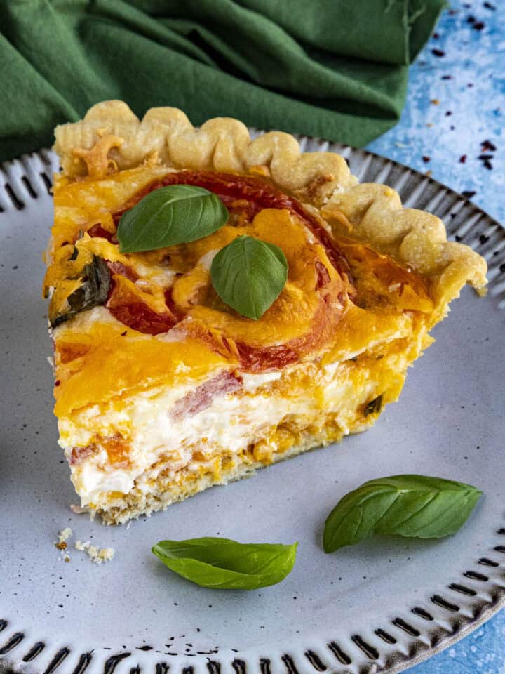 A thick slice of Southern Tomato Pie on a plate