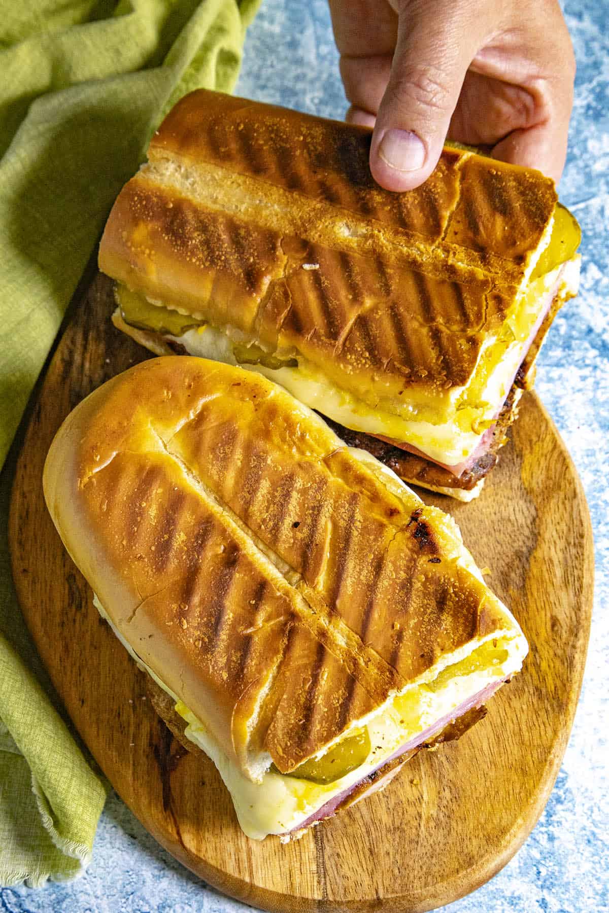 Mike taking half of a Cuban Sandwich from the serving platter