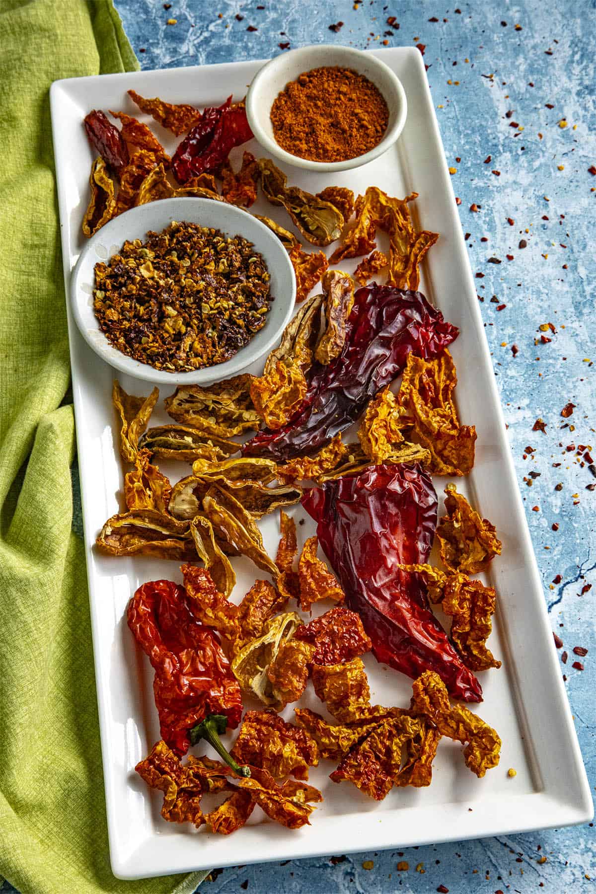 A Colorful Collection of Dehydrated chili peppers, chili flakes, and chili powder on a platter