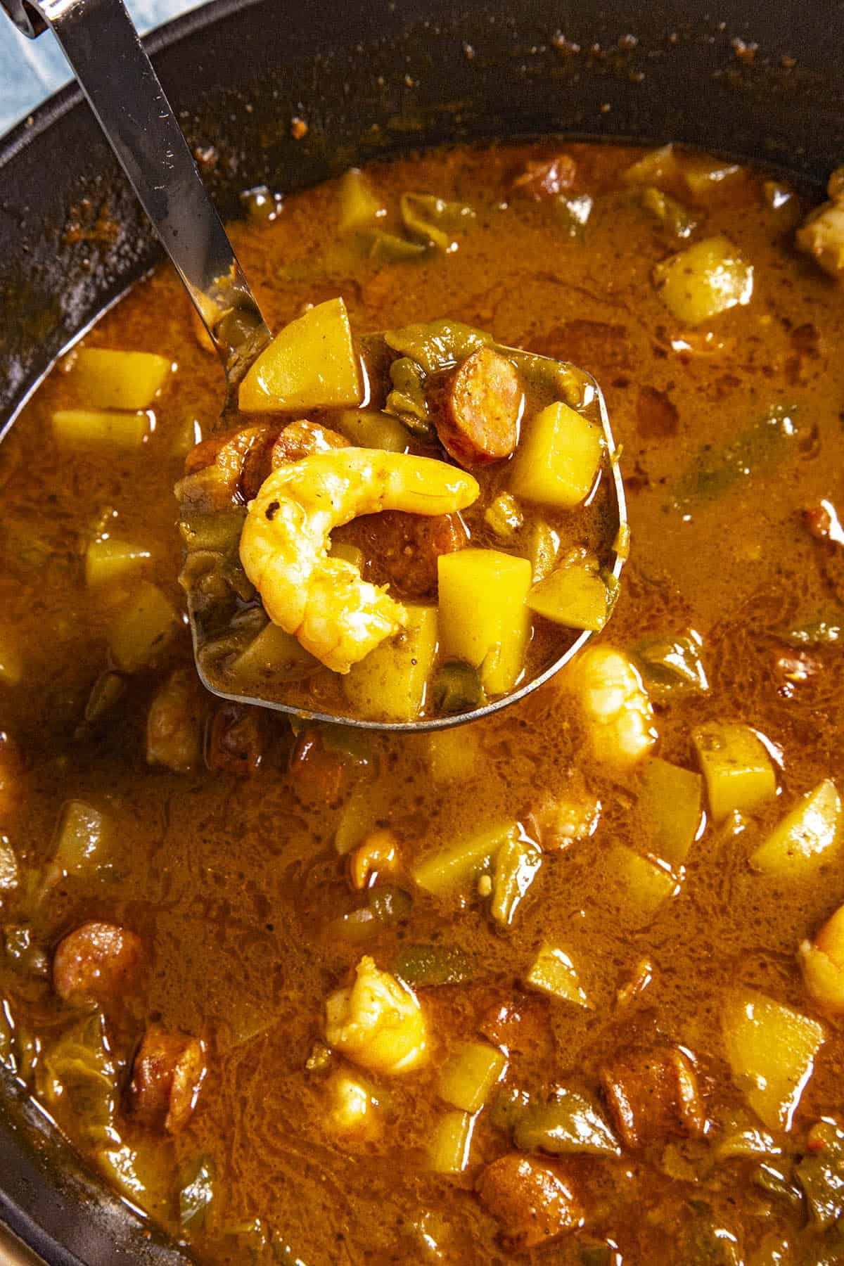 Mike serving a scoop of chunky and delicious Green Chili Stew with Shrimp