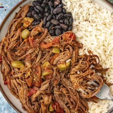 Ropa Vieja (Cuban Shredded Beef) in a bowl with rice and black beans