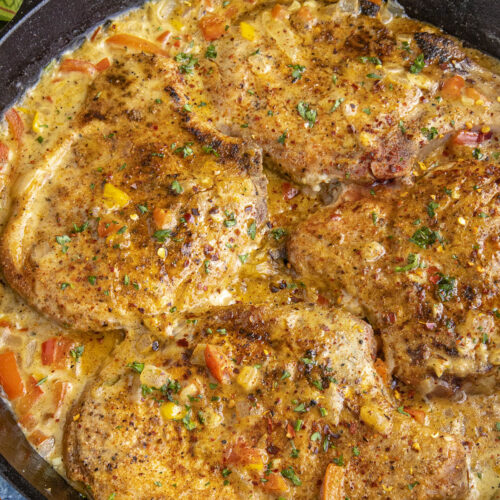 Smothered Pork Chops in a pan, ready to serve