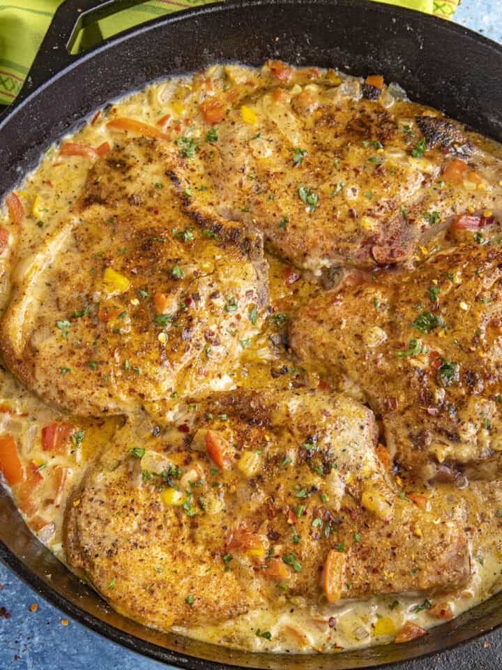 Smothered Pork Chops in a pan, ready to serve