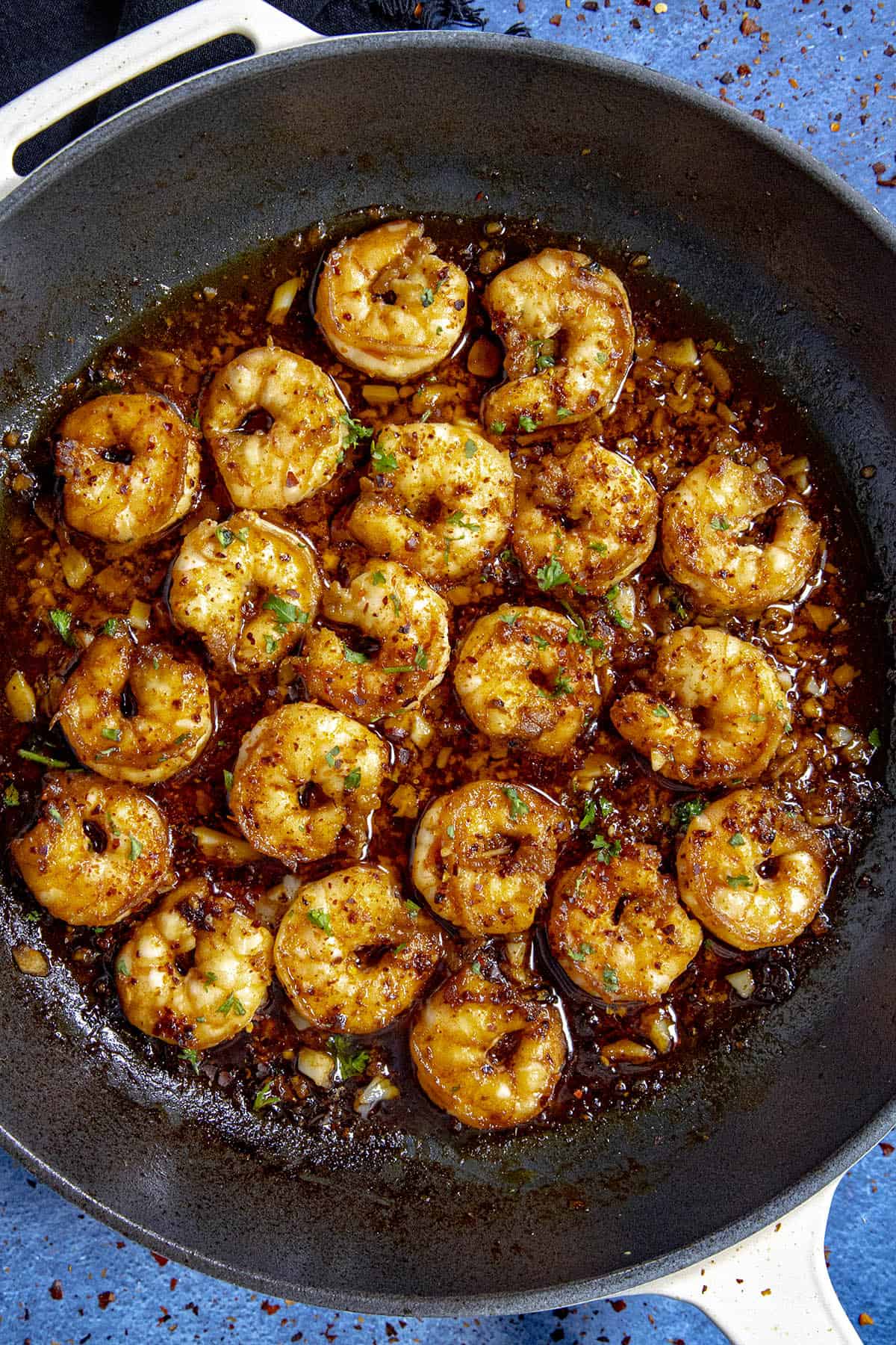 Chili Crisp Shrimp in a pan with garnish