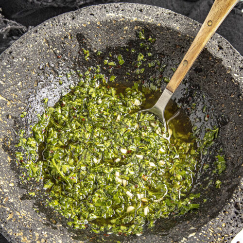 Mashing Chimichurri in a bowl (Chimichurri Sauce)