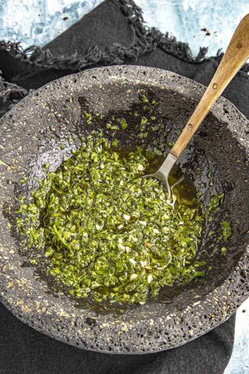 Mashing Chimichurri in a bowl (Chimichurri Sauce)