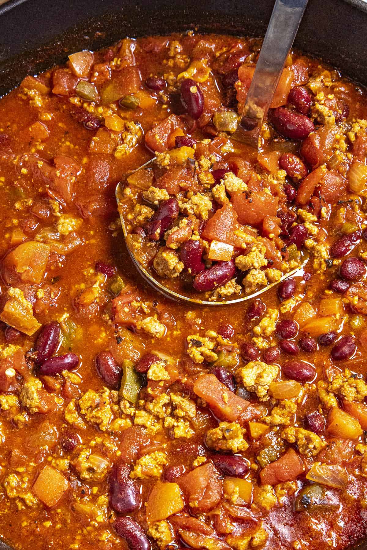 Mike serving turkey chili from the pot