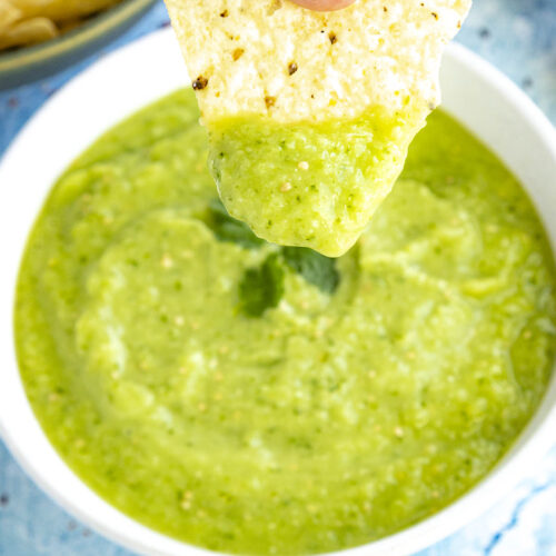 Mike scooping Creamy Avocado Salsa Verde with a Tortilla Chip