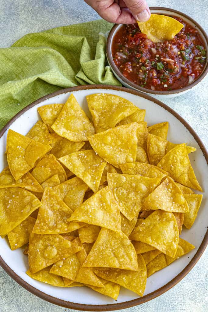Mike dipping a Homemade Tortilla Chip into a bowl of salsa