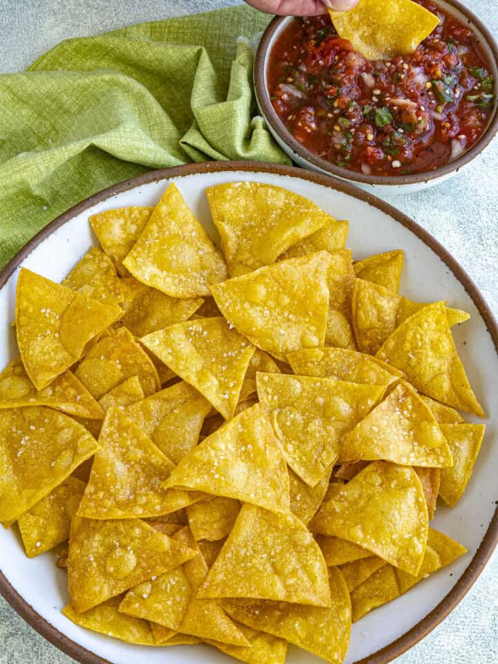 Mike dipping a Homemade Tortilla Chip into a bowl of salsa