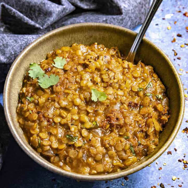 A bowl of Misir Wot (Ethiopian Spicy Red Lentils) with a spoon