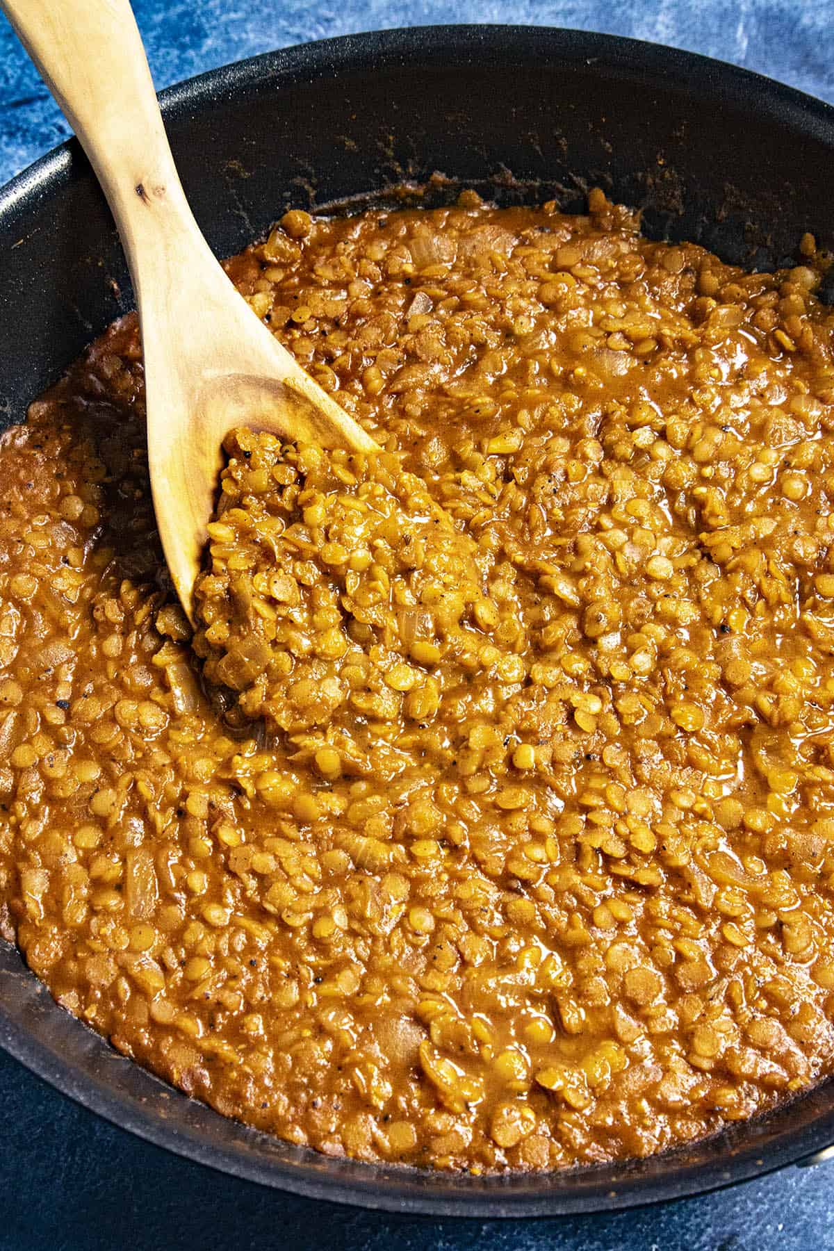Mike taking a scoop of Misir Wot (Ethiopian Spicy Red Lentils) from the pot