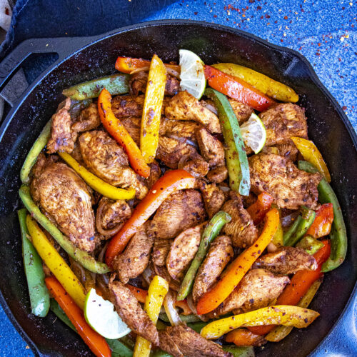 Sizzling chicken fajitas in a pan, ready to serve