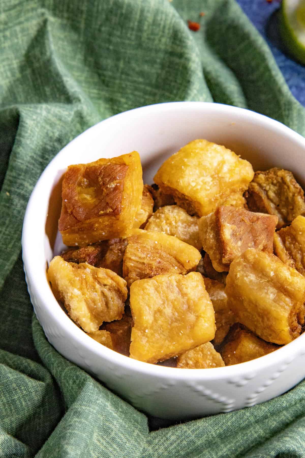 A bowl of Homemade Chicharrones on a table, ready to be enjoyed