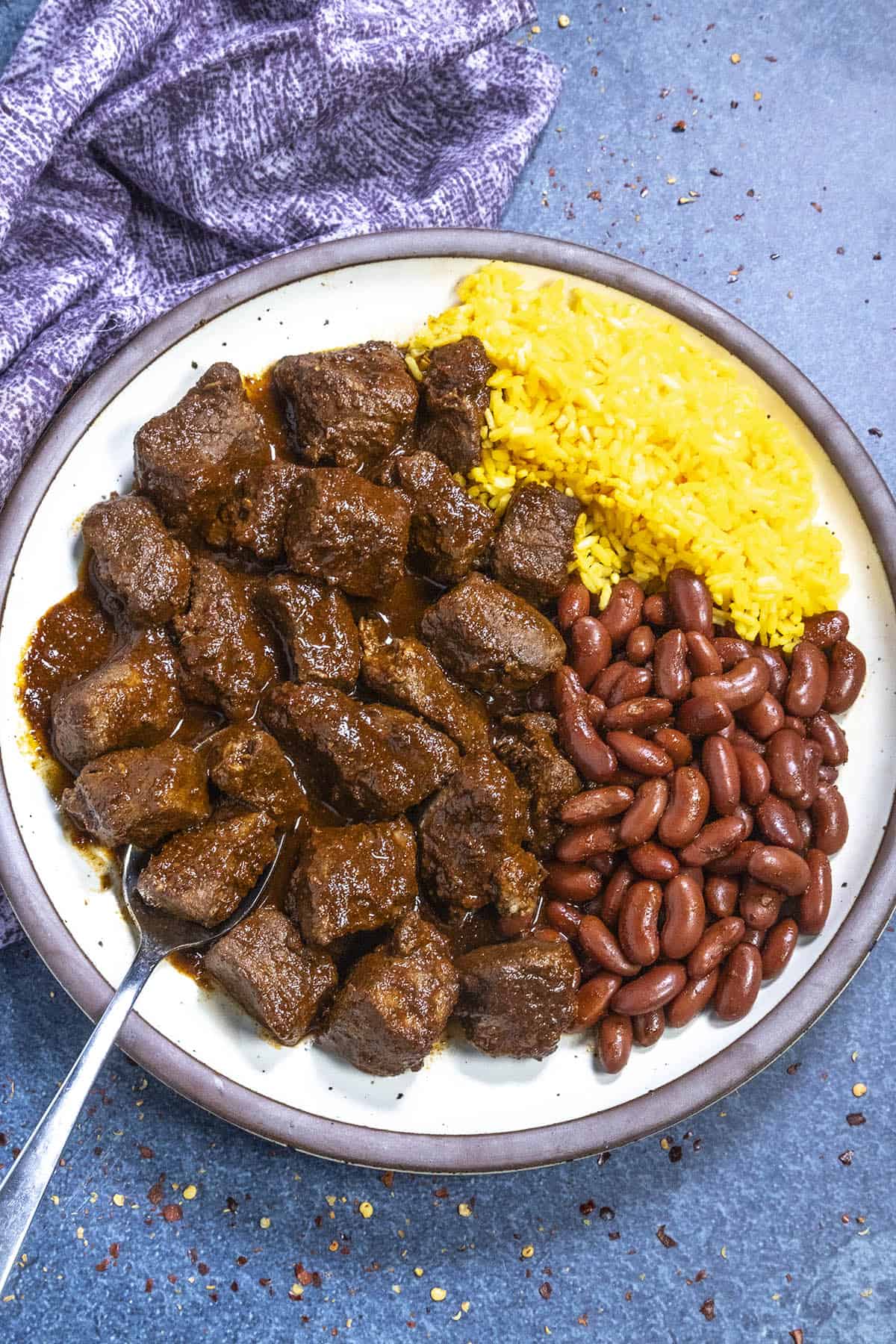 Asado de Puerco served on a plate with Mexican rice and beans