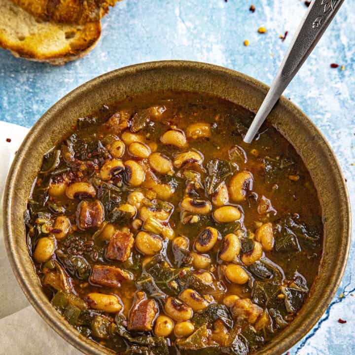 A bowl of Black Eyed Peas Soup served with grilled crusty bread for sopping