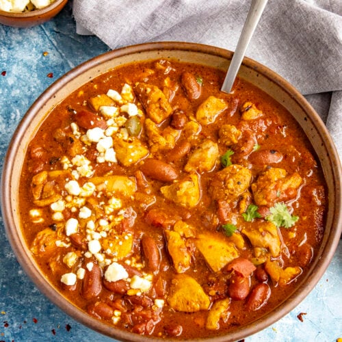 A large bowl of spicy Buffalo Chicken Chili with blue cheese crumbles on top