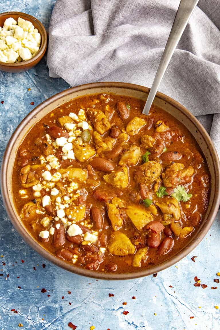 A large bowl of spicy Buffalo Chicken Chili with blue cheese crumbles on top