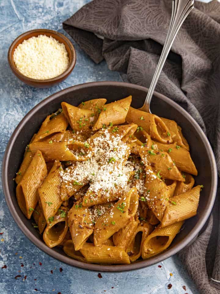 Zesty Gochujang Pasta in a bowl with grated Parmesan cheese on top