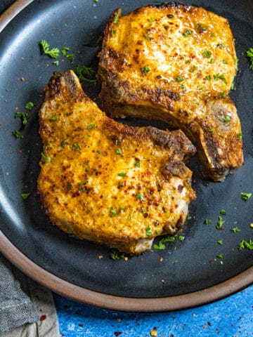 Air Fryer Pork Chops served on a plate with garnish