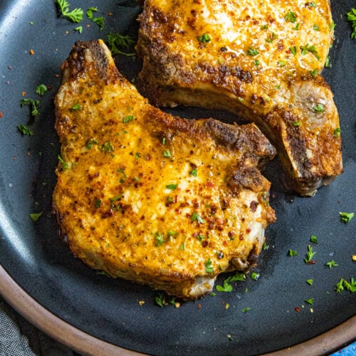 Air Fryer Pork Chops served on a plate with garnish