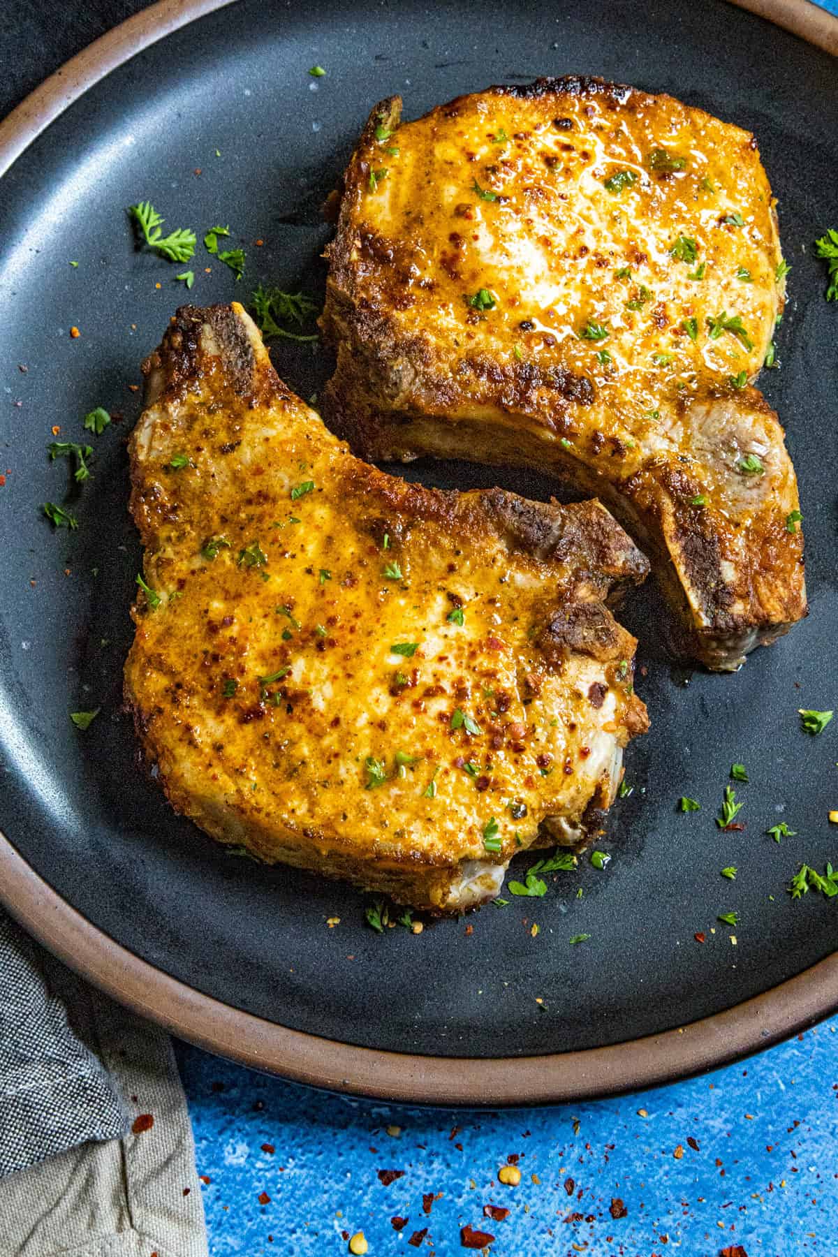 Air Fryer Pork Chops served on a plate with garnish