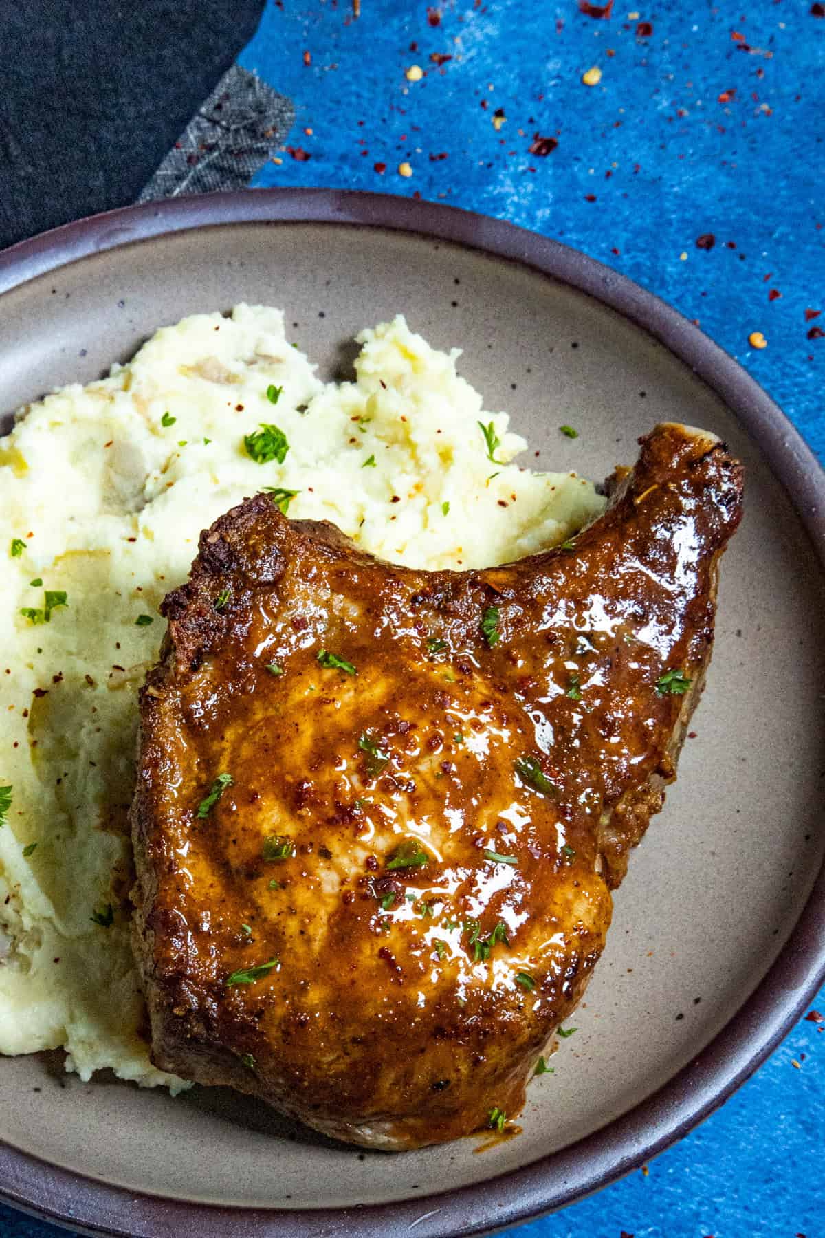A thick and juicy Air Fryer Pork Chop served over mashed potatoes