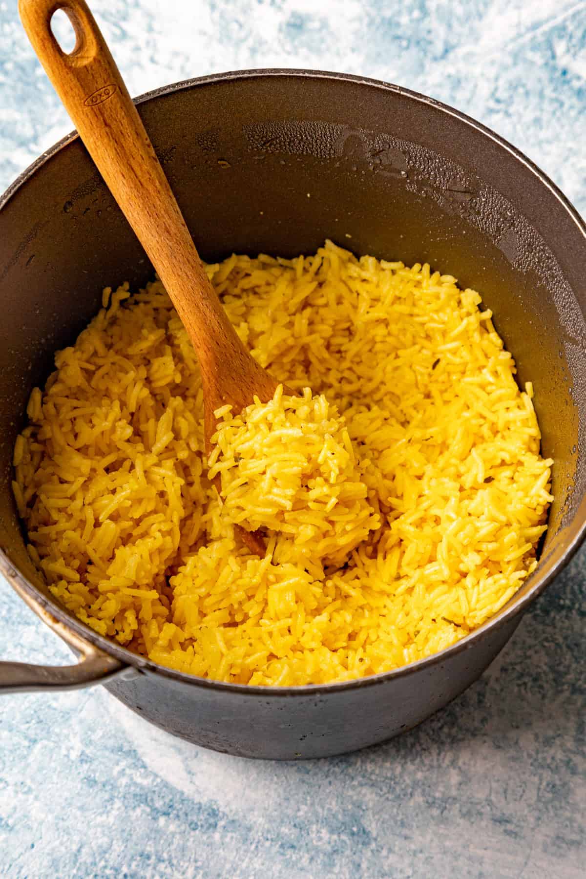 Fluffy yellow rice in a pot, ready to serve