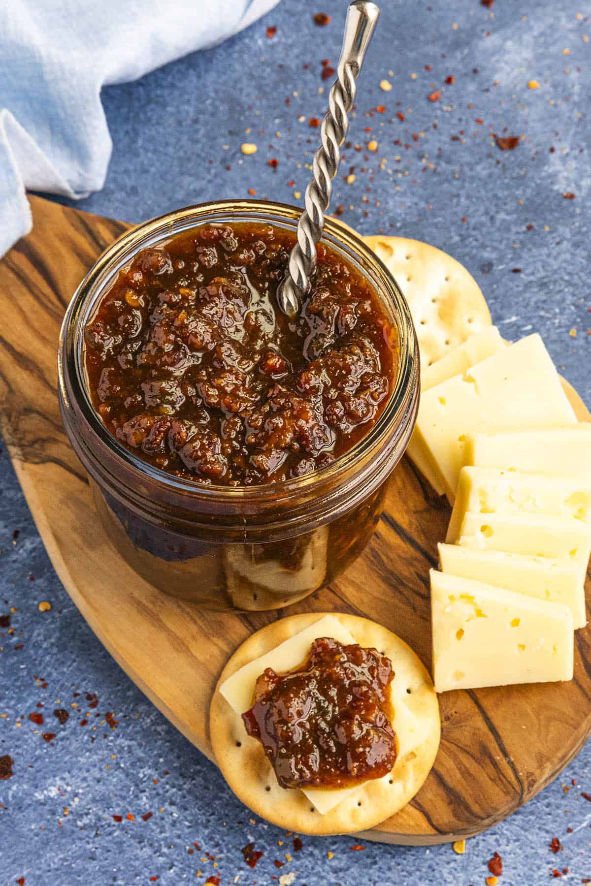 Gooey Bacon Jam on a platter served with crackers and cheese