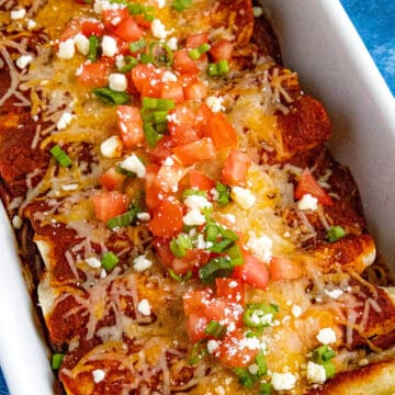 Cheese enchiladas with chopped tomato and green onion - easy, melty, and loaded with bold flavor.