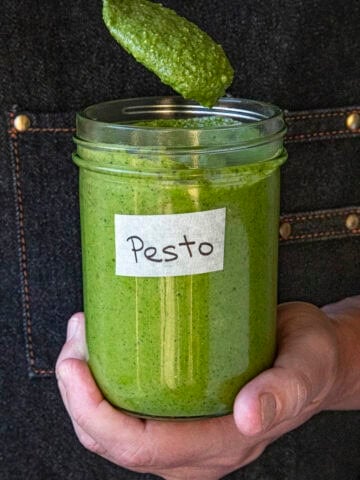 Mike holding a jar of homemade pesto
