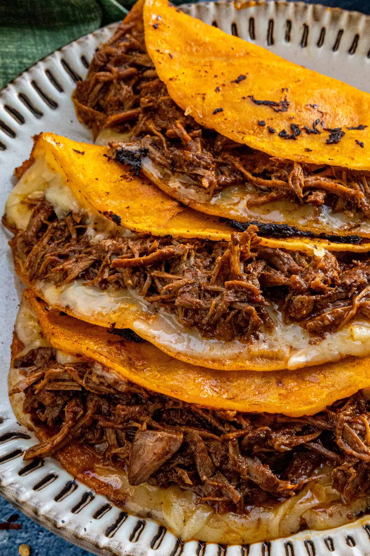 Cheesy quesabirria tacos on a plate