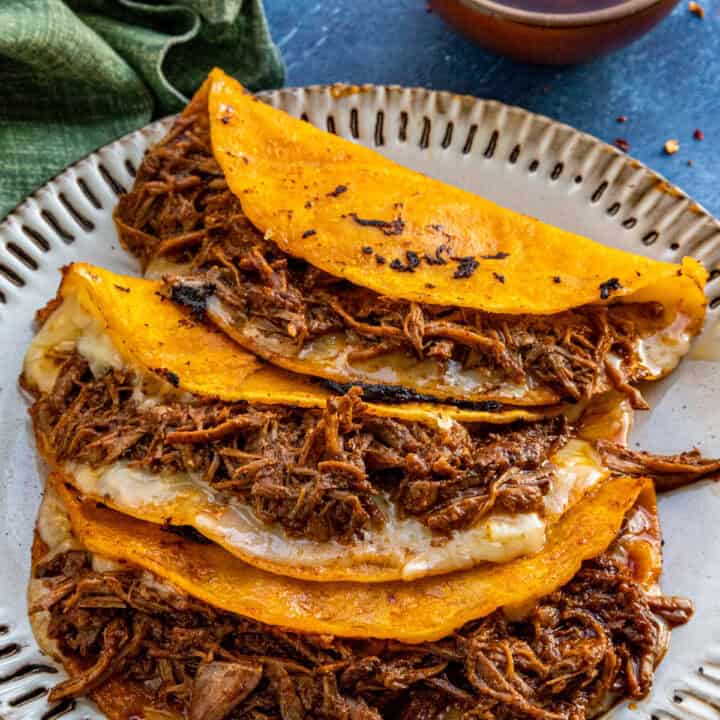 Quesabirria tacos served with birra sauce