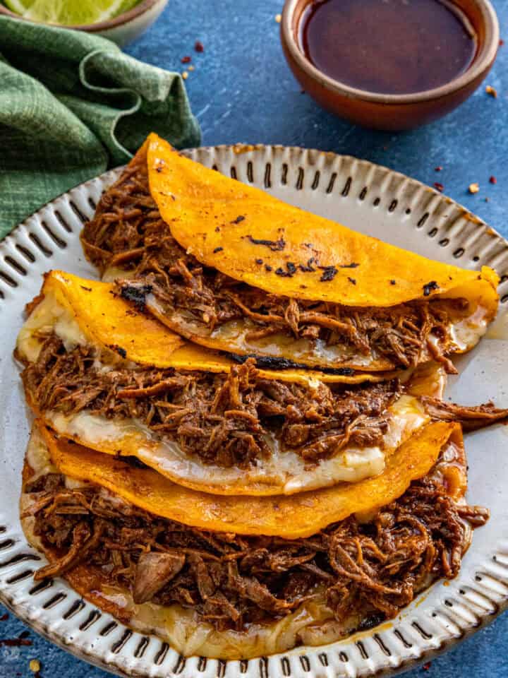 Quesabirria tacos served with birra sauce