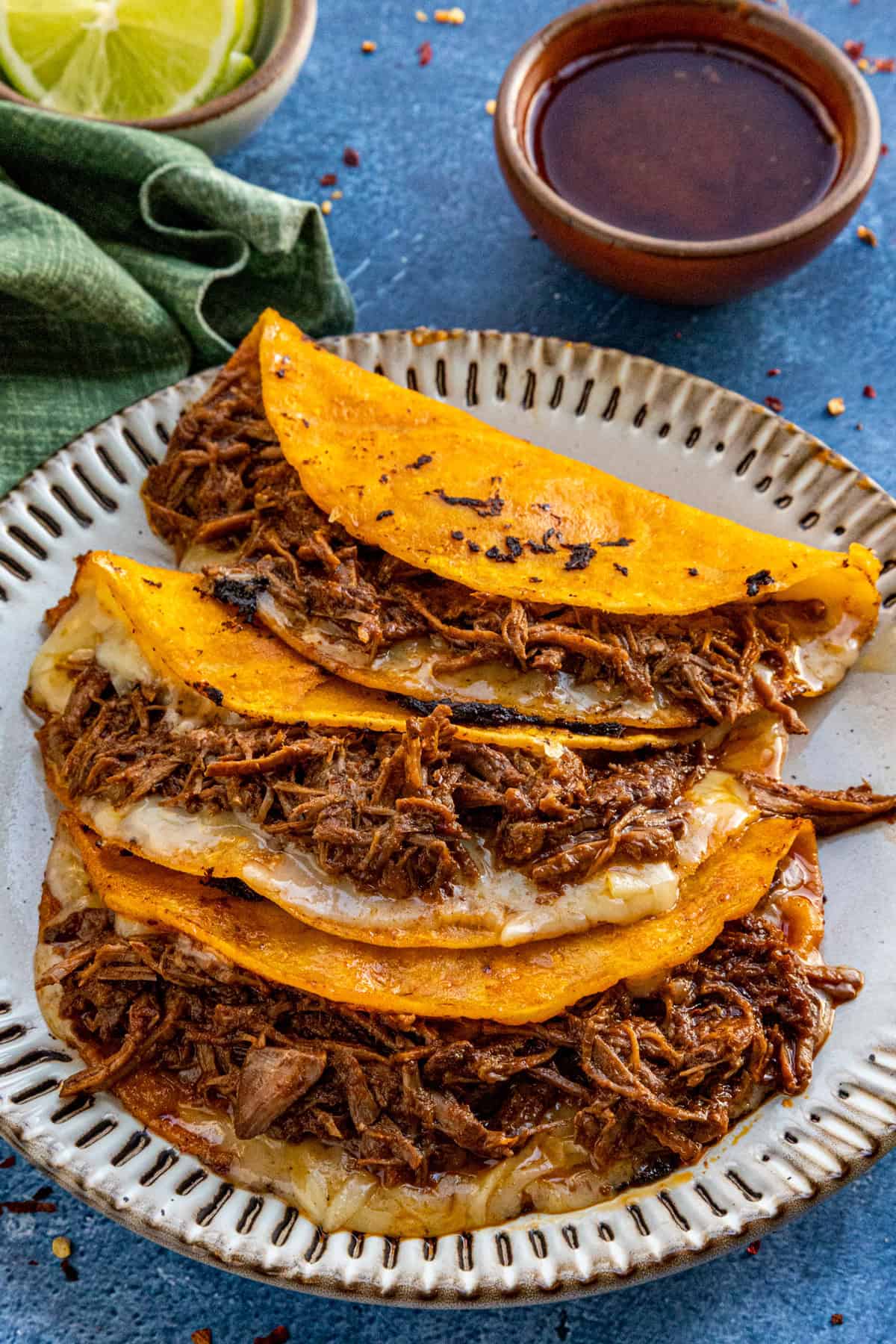 Quesabirria tacos served with birra sauce