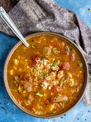 A large bowl filled with Jambalaya Soup, loaded up with lots of chicken and andouille sausage