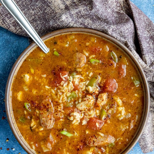 A large bowl filled with Jambalaya Soup, loaded up with lots of chicken and andouille sausage
