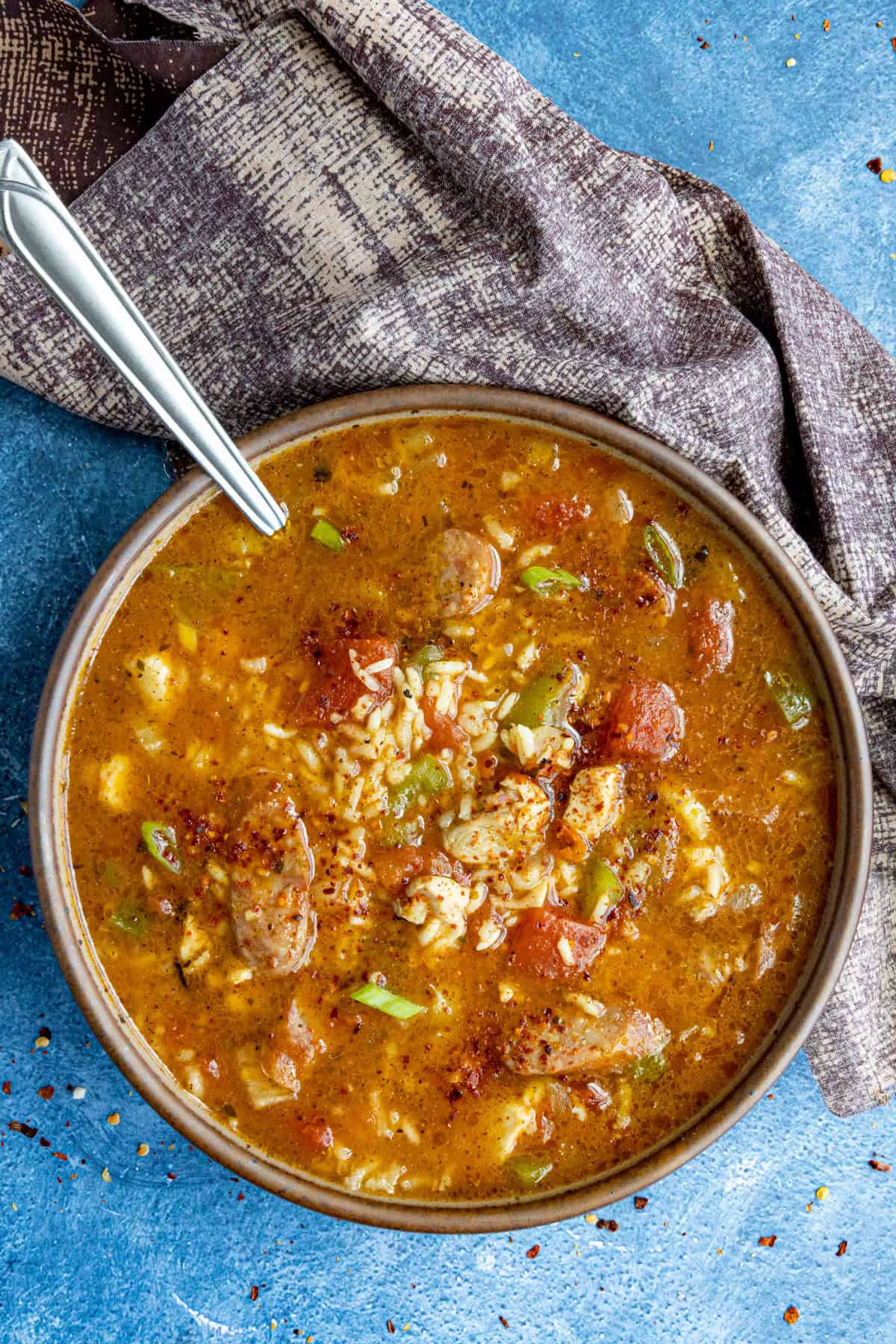 A large bowl filled with Jambalaya Soup, loaded up with lots of chicken and andouille sausage