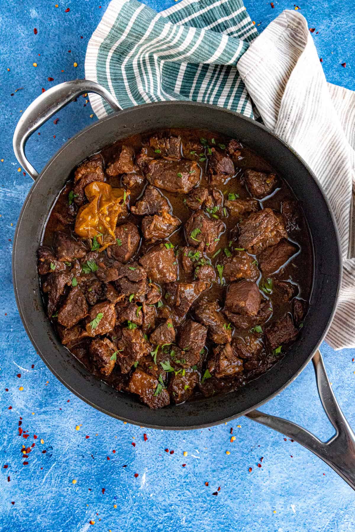Spicy Pepperpot served up in a large pot with garnish