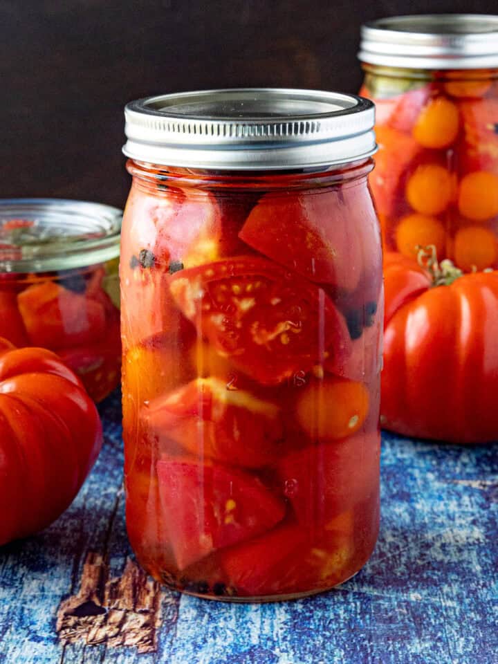 A large jar of Pickled Tomatoes on a table
