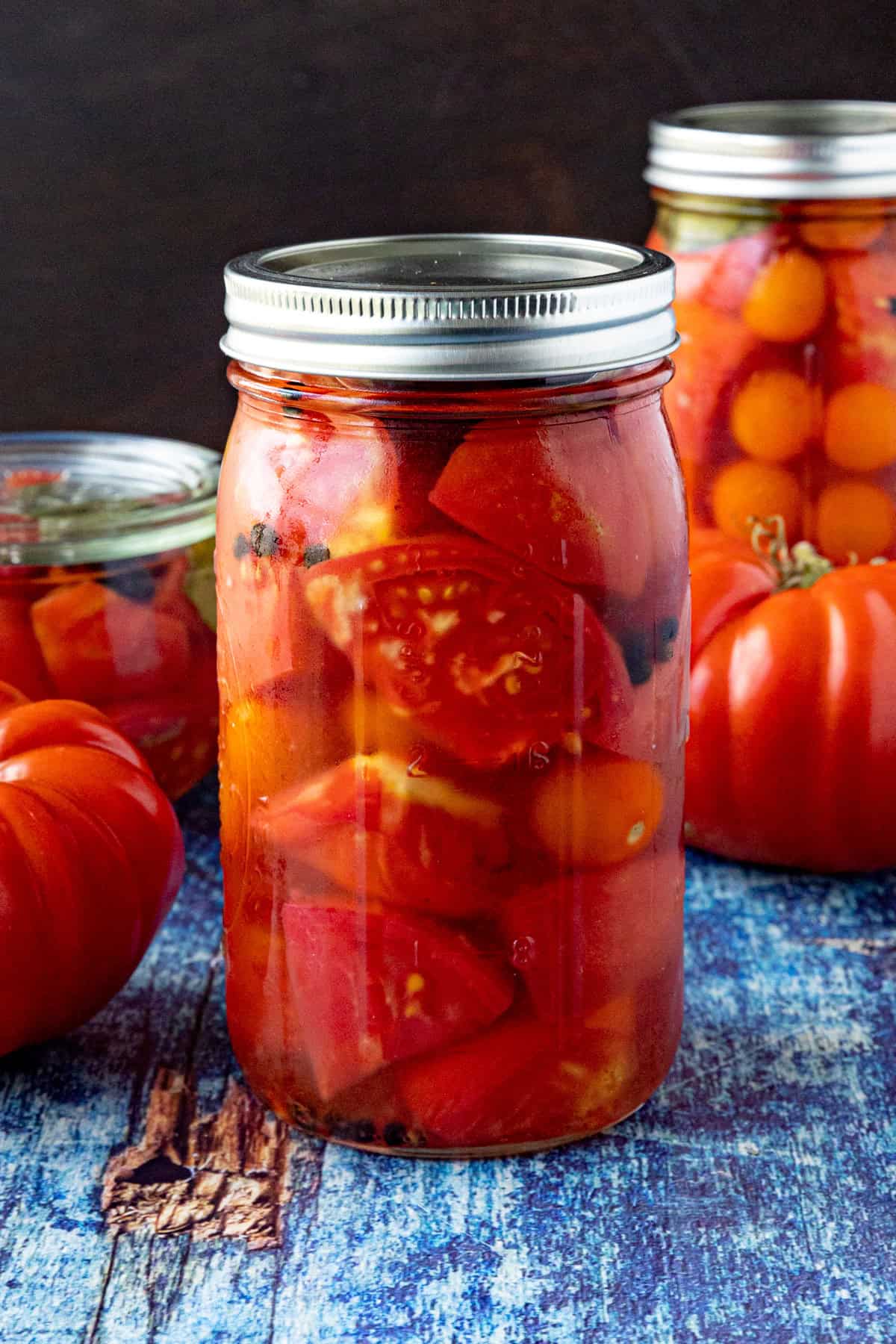 A large jar of Pickled Tomatoes on a table