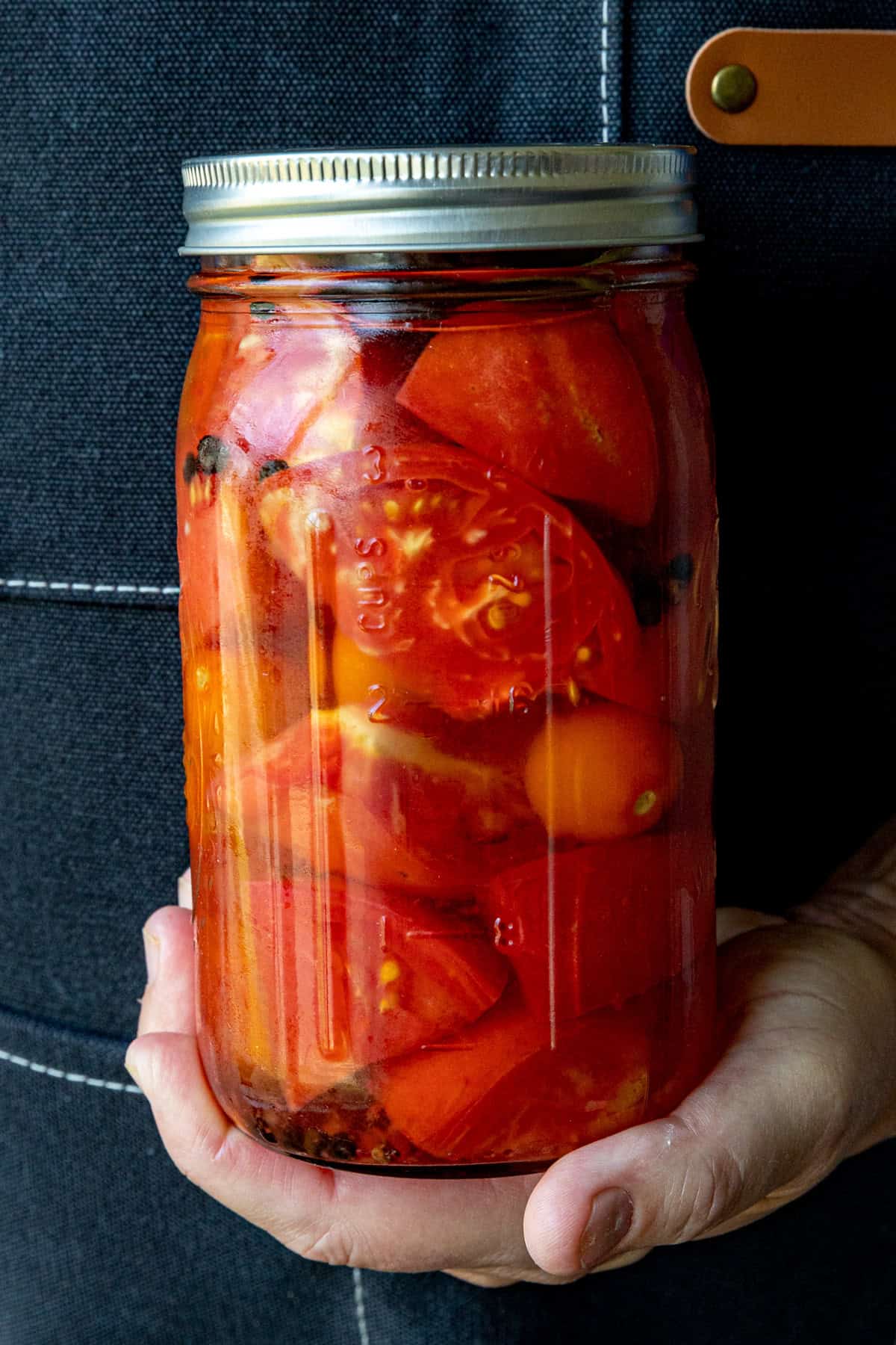 Mike holding a jar of Pickled Tomatoes