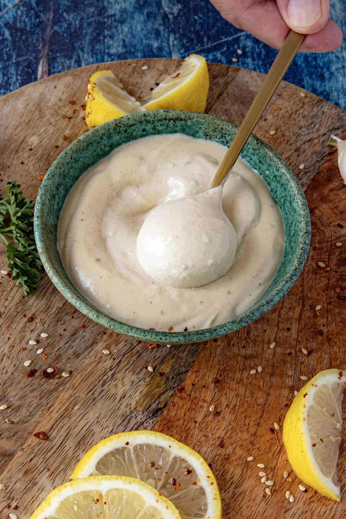 Scooping Creamy Tahini Sauce from the bowl