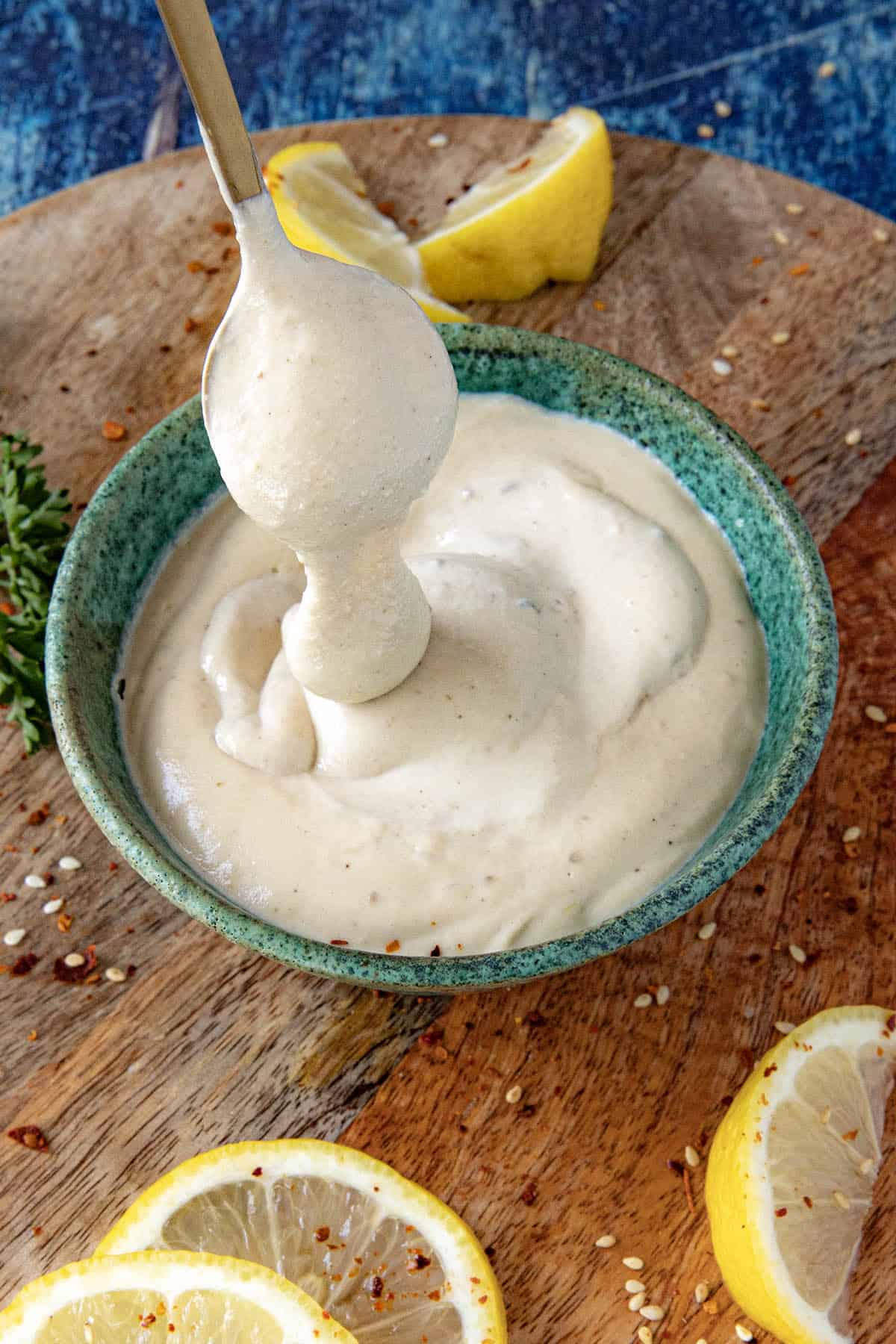 Creamy Tahini Sauce dripping from a spoon